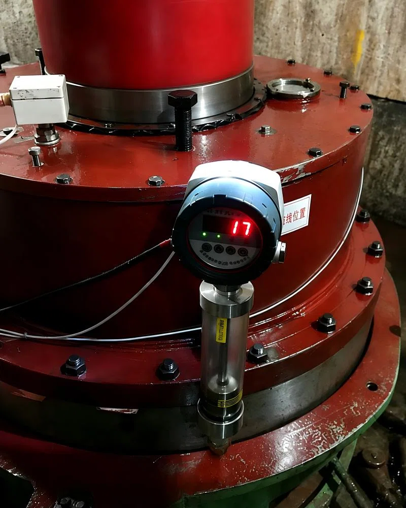Tubular oil level gauge installed on heavy machinery.