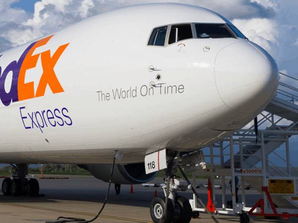 A plane of FedEx landed on the ground.