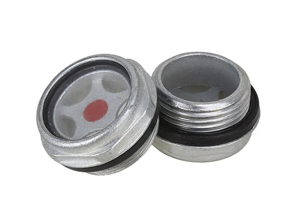 Two pieces of oil sight glass made of aluminum alloy with plastic window on the white background.