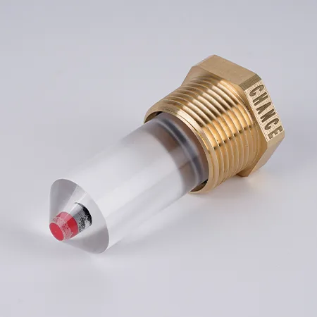 Образец рефлекторного указателя уровня масла, лежащий на столе.