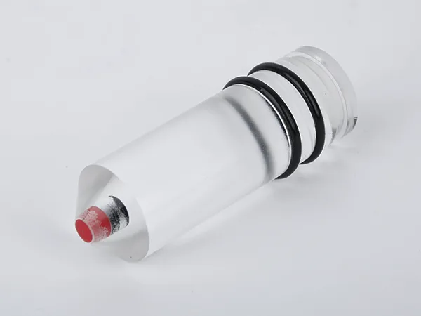 The reflex oil level gauge without a nut lying flat on the desk.