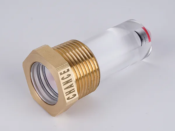 The reflex oil level gauge with a nut is lying flat on the table.