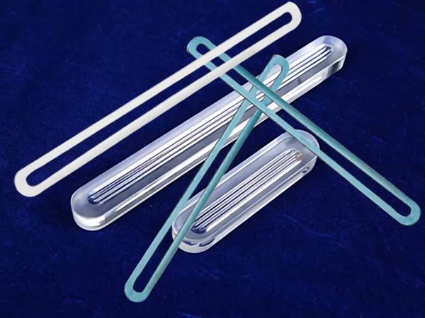 There are a few pieces of accessories together with transparent gauge glass on the ground.